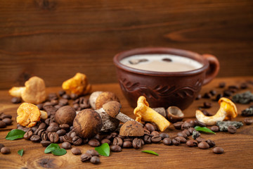 Fototapeta na wymiar Concept of trend modern food industry. Mushroom coffee from mushrooms Chaga, a ceramic cup on a wooden background with coffee beans. Cappuccino, hipster, latte, instagram. Copy space, selective focus.