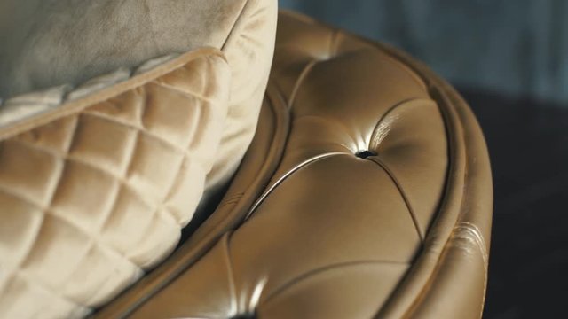 Close up leather pattern of a gold luxury sofa in the living room for background texture