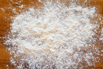Top side view on white flour on rustic wooden table background, closeup of healthy cooking copyspace surface at home, restaurant, fabric plant