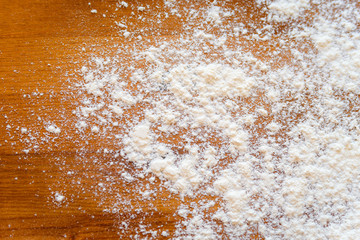 Top side view on white flour on rustic wooden table background, closeup of healthy cooking copyspace surface at home, restaurant, fabric plant