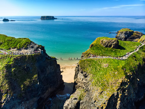 Fototapeta Carrick-a-Rede Rope Bridge, famous rope bridge near Ballintoy in County Antrim, linking the mainland to the tiny island of Carrickarede