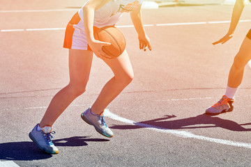 Naklejka premium Girls teenagers basketball player play and train on the basketball.