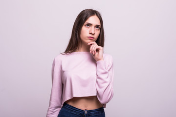 Portrait of beautiful woman thinking and touching chin isolated over white background