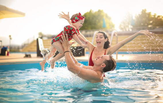 Beautiful family having fun in a swimming pool