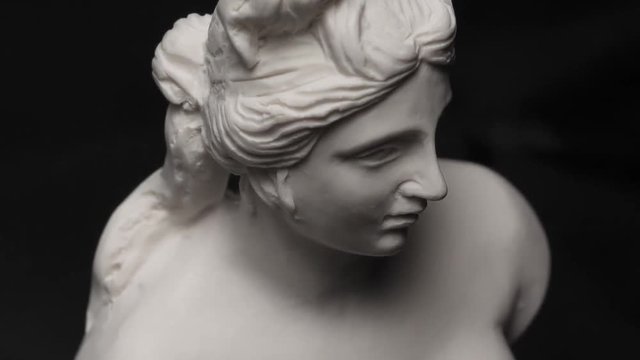 Old antique white marble roman sculpture closeup.