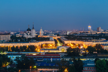 Fototapeta na wymiar Night Voronezh downtown. View to Voronezh railway station, Mira Street, South-eastern railway main building and Annunciation Cathedral