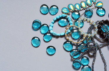 Accessories, collection, blue crystals, glass decorations on a light background, glamorous photo, fashion, female style, a combination of colors