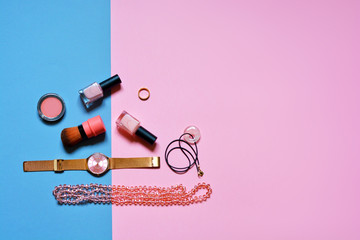 Cosmetics and accessories in pastel colors, a set of female things on a pink background, a nude tone, nail polish, earrings, bijouterie