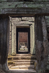 Fototapeta na wymiar Ancient temple gate, Angkor Wat landmark, Cambodia. Ancient temple in Siem Reap. Angkor Wat detail.
