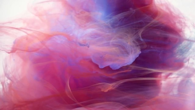 Abstract Ink colours flowing in water. Purple, yellow and orange Ink colours.