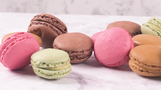 Macarons macaroons cookies dessert from France isolated on a white marble countertop.