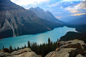 Peyto Lake view from Bow Summit along the Columbia Icefields Parkway in Banff National Park, Canada, turquoise glacier water, mountains and clouds in the background