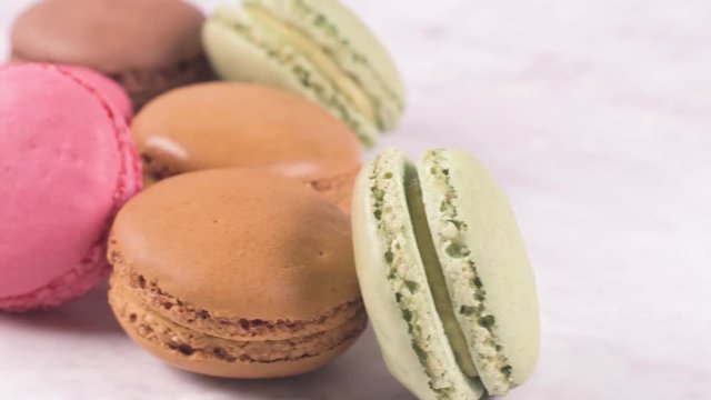 Macarons macaroons cookies dessert from France isolated on a white marble countertop.