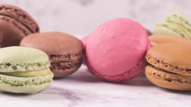 Macarons macaroons cookies dessert from France isolated on a white marble countertop.