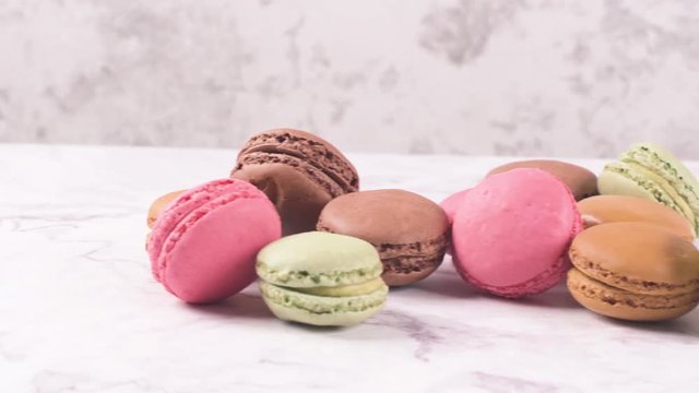Macarons macaroons cookies dessert from France isolated on a white marble countertop.