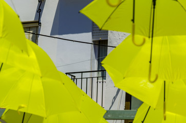 Colourful umbrellas urban street decoration. Hanging colorful umbrellas over blue sky, tourist attraction