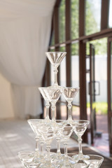 a slide of champagne glasses in a luxurious airy summer restaurant in white color ready to party