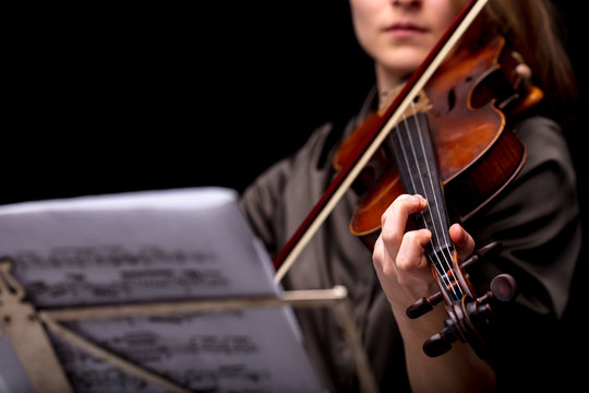 violinist playing in front of her score