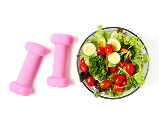 Mixed vegetables salad and fitness equipment on white background.