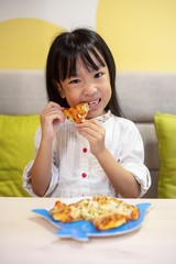 Asian Little Chinese Girl Eating pizza