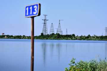 high-voltage poles outside Lake. Road sign 113