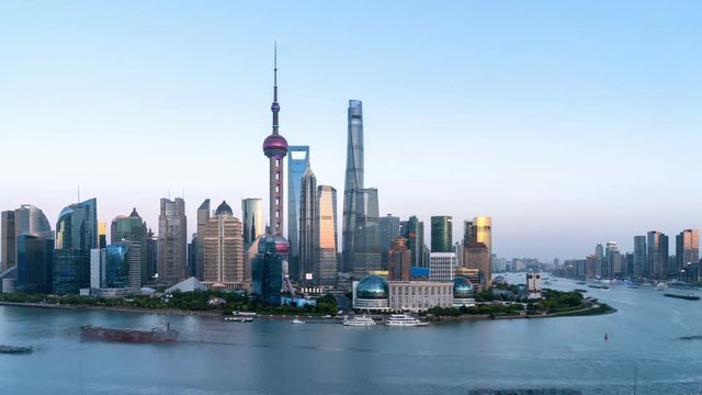 time lapse of shanghai financial center in nightfall, busy huangpu river and beautiful pudong skyline