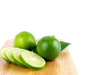 Lemon is sliced on a wooden cutting board on a white background isolated with copy space