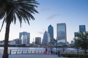 Fototapeta na wymiar Jacksonville, FL/ USA 07/25/2017- The Jacksonville skyline can be seen across the water as evening sets in.