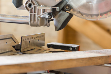 Saw the board. The man saws the board with an electric saw. Joinery.