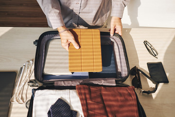Man packing suitcase