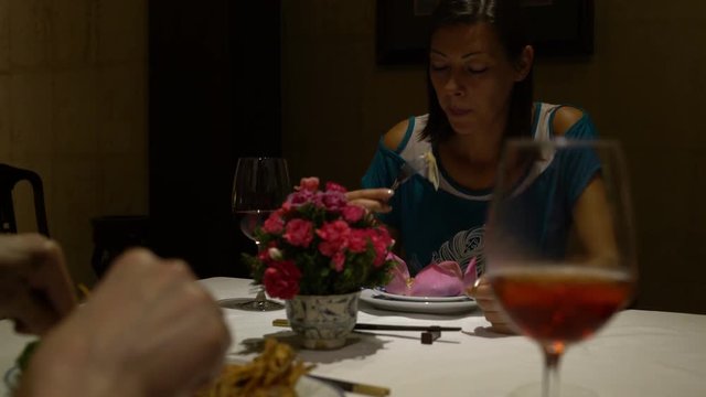 Girl eats at the restaurant at a table and talking
