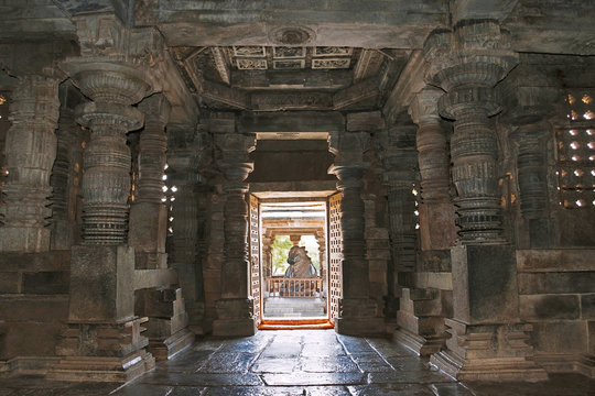 Interior view of Hoysaleshvara shrine hall. Nandi in the mandapa at the eastern entrance is cearly seen. Hoysaleshvara Temple, Halebid, Karnataka