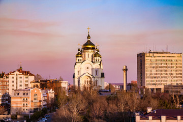Fototapeta na wymiar Khabarovsk cityview in the sunset with a cathedral on the horizon