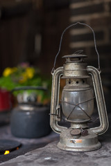 Old lantern, smoky coffee pot on background