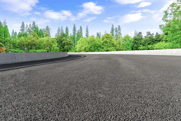 Asphalt road square and river hill under the blue sky