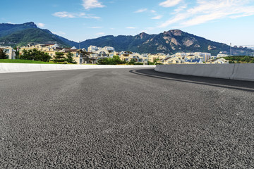 Asphalt road square and river hill under the blue sky