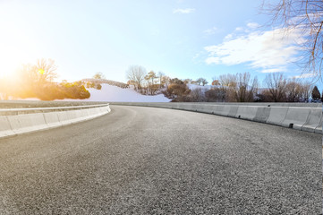 Asphalt road square and river hill under the blue sky