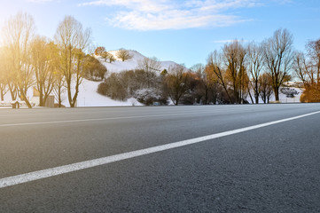 Asphalt road square and river hill under the blue sky