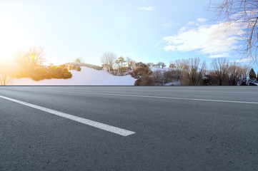 Asphalt road square and river hill under the blue sky