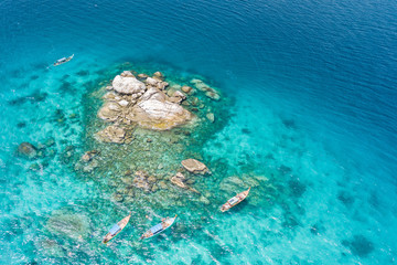 Fototapeta na wymiar Aerial view of unidentified tourists snorkeling activity on tropical island near Lipe Island, Satun, Thailand.