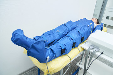 liposuction blue pressotherapy. Doctor help lose weight and slimming. Model at costume in salon