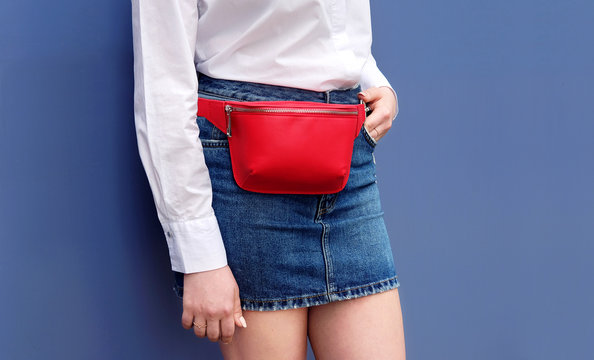 Trendy red stylish belt leather bag on woman