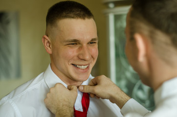 
witness at the wedding tie a groom
