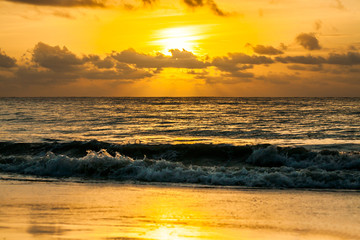 Dramatic sunset sky with clouds over ocean.