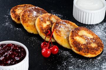 Sweet delicious cottage cheese pancakes with powdered sugar and 
