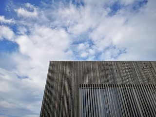 Fototapeta na wymiar Wooden modern building with amazing sky, contemporary architecture with refined lines and minimalist design 