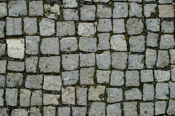 Abstract background of granite old cobblestone pavement. Paving 