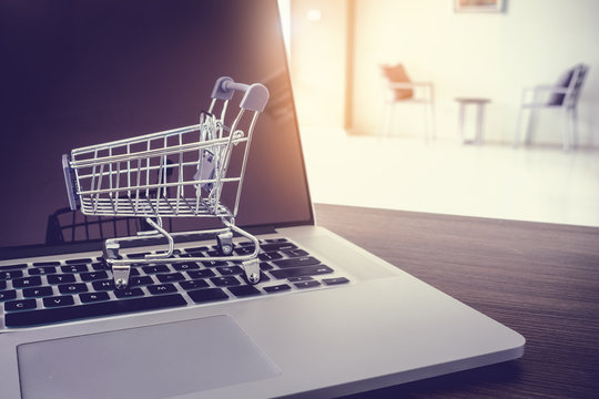 Shopping online concept, Mini trolley on keyboard laptop