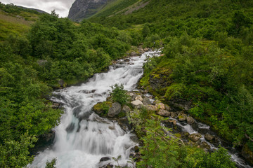 Naklejka na ściany i meble Waterfall view in Norway summer trip