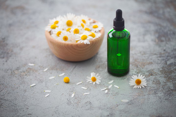 essential oil with camomile flowers